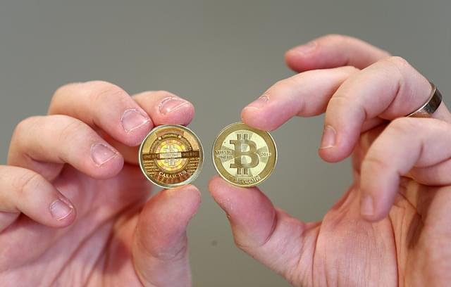 A software engineer shows the front and backa physical Bitcoin he minted in his shop in Sandy, Utah, US.&nbsp; (George Frey/GettyImages)