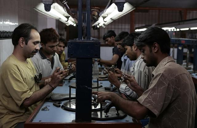 Workers busy polishing diamonds at a factory in Dahisar (Satish Bate/Hindustan Times via Getty Images)