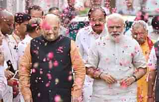 Prime Minister Narendra Modi and BJP president Amit Shah are welcomed at the party headquarters in New Delhi after the party scored significant victories in assembly polls. (Sonu Mehta/Hindustan Times via Getty Images)