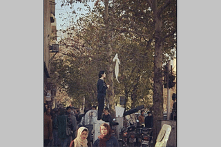 A woman waves a hijab during protests in Iran. (Twitter)