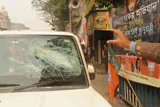 A BJP supporter’s damaged car in front of the party office after tension between BJP and Trinamool supporters in Kolkata. (Samir Jana/Hindustan Times via Getty Images)