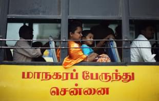A lady with a young boy on her lap look out the window as they ride the bus. The transport employees have been risking their lives to ensure the communters’ safety. (Mark Kolbe/Getty Images)