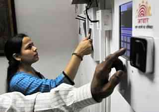 Employees mark their attendance through Aadhaar based System. (Vipin Kumar/Hindustan Times via Getty Images)