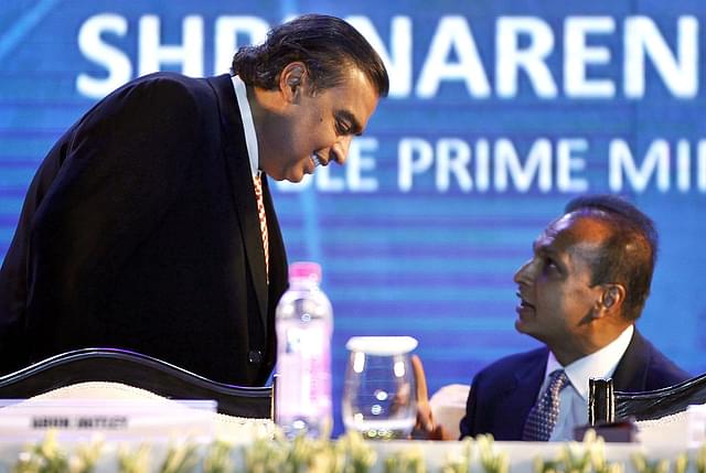 Mukesh Ambani and Anil Ambani during the launch of Digital India Week by Prime Minister Narendra Modi in New Delhi. (Ajay Aggarwal/Hindustan Times via GettyImages)