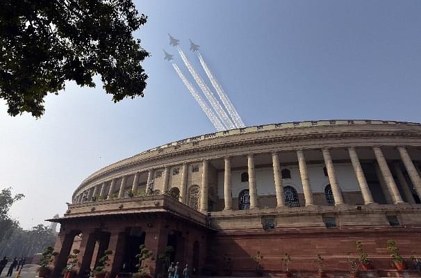 Indian Air Force aircraft fly past the Parliament House. (Sonu Mehta/Hindustan Times via Getty Images)