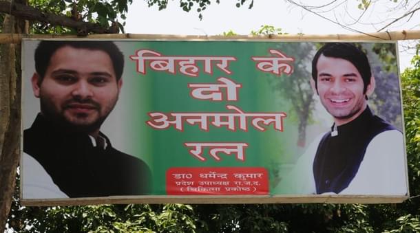 The banner reads “The 2 Priceless Gems of Bihar”. Tejashwi Yadav (L) with Tej Pratap Yadav. (AP Dube/Hindustan Times via Getty Images) 