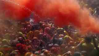 Hindu devotees play with coloured powders during Holi celebrations at the Bankey Bihari Temple in Vrindavan, India. (Majid Saeedi/Getty Images)