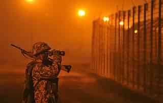 An Indian Army soldier stands guard at the International border in Jammu. (Nitin Kanotra/Hindustan Times via Getty Images)