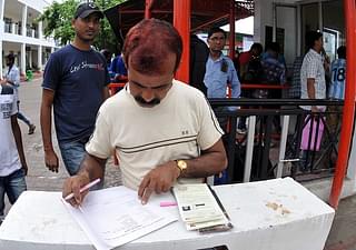 A devotee filling his registration form in a queue at Base Camp in Jammu in 2017