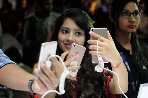 A woman takes a selfie on a smartphone. (Burhaan Kinu/Hindustan Times via Getty Images)