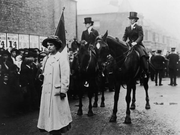 A flag carrier and two mounted marshals (riding astride) in a suffragette march through London in support of the Women’s Suffrage Bill, June 1910. (Hulton Archive/Getty Images)