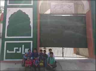 Children of Qaumi Sr. Sec. School in front of main entrance of the school.