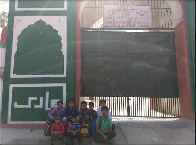 Children of Qaumi Sr. Sec. School in front of main entrance of the school.