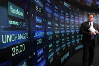 A reporter waits for the share price of Facebook to start trading at the Nasdaq stock market moments before it went public. (Spencer Platt/Getty Images)