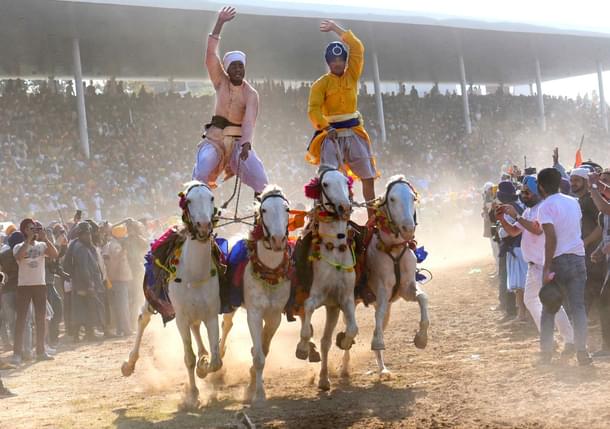 Nihangs performing horse riding skills during the Hola Mohalla festival at Anandpur Sahib. (Sanjeev Sharma/Hindustan Times via Getty Images)