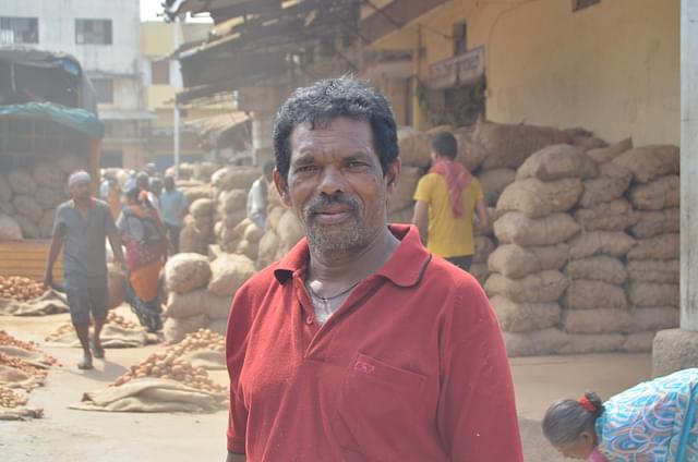 Daily worker Selvaraj near the potato auction platform at the Yeshwanthpur APMC Yard