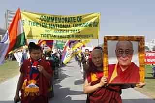 Exiled Tibetans monks hold the portrait of Dalai Lama during a protest march in New Delhi marking the anniversary of a failed 1959 uprising against China’s rule in Tibet. (Virendra Singh Gosain/Hindustan Times via Getty Images)&nbsp;
