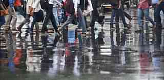  Pedestrians crossing a wet road after a heavy shower in Mumbai. (Arijit Sen/Hindustan Times via Getty Images)