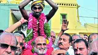  Chilukuru Balaji Archakulu C S Rangarajan lifting Aditya Parasri on his shoulders as a part of the Muni Vahana Seva utsavsam at Sri Ranganatha Swamy temple Puranapul in Hyderabad. (Deccan Chronicle).