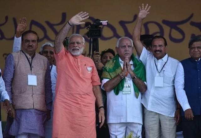 Prime Minister Narendra Modi with BJP’s chief ministerial candidate for upcoming Karnataka assembly election B S Yeddyurappa at a rally. (Arijit Sen/Hindustan Times via GettyImages)