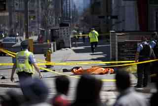 A tarp lays on top of a body on Yonge St. at Finch Ave. (Cole Burston/Getty Images)