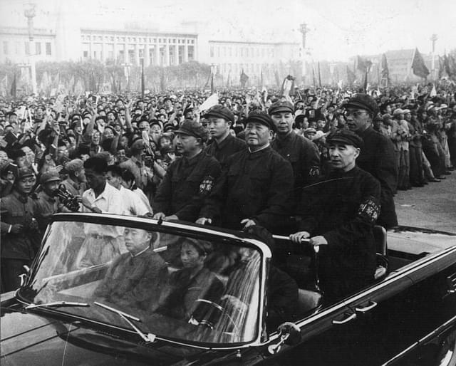 Chinese leader Mao Tse-tung (1893-1976), accompanied by his second-in-command Lin Biao (1907-1971), passes along the ranks of revolutionaries during a rally in Tiananmen Square, Peking (Beijing), 1966. (Keystone/Getty Images)