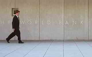 A man passes by the sign of World Bank Group September 2000 outside the World Bank headquarters in Washington. (Alex Wong/Newsmakers)&nbsp;