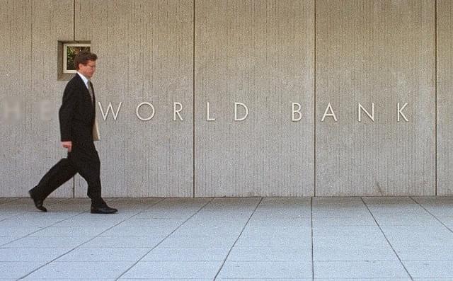 A man passes by the sign of World Bank Group September 2000 outside the World Bank headquarters in Washington. (Alex Wong/Newsmakers)&nbsp;