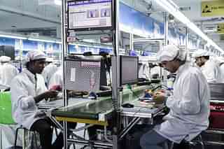 Technicians assemble smartphones on the production line in Noida. (Udit Kulshrestha/Bloomberg via Getty Images)