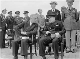 Franklin D Roosevelt and Winston Churchill seated on the quarterdeck of HMS Prince of Wales following a Sunday service during the Atlantic Conference, 10 August 1941. (Wikimedia Commons)