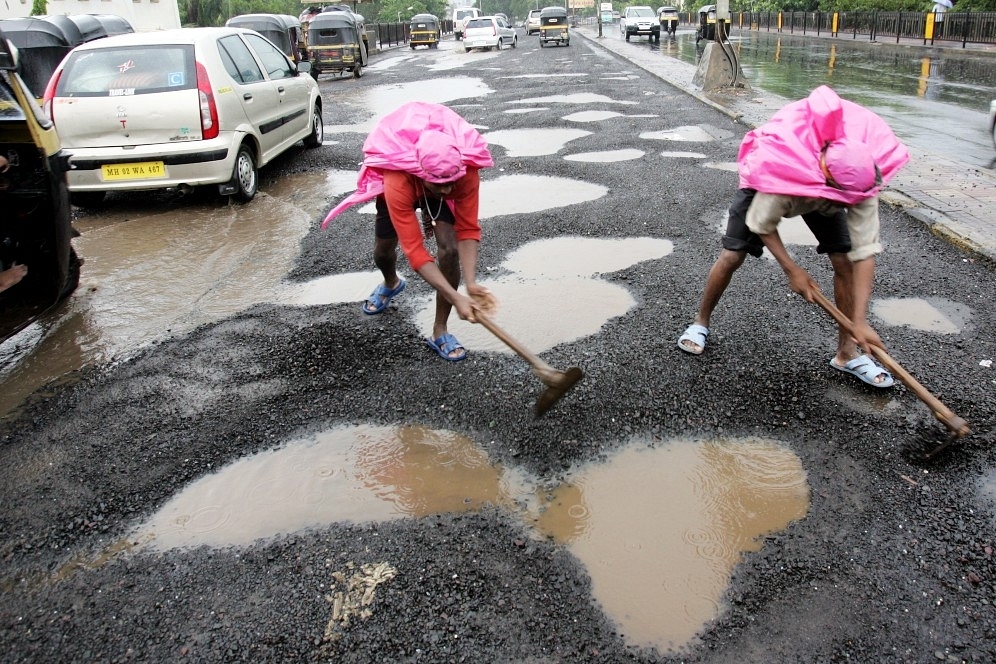 Potholes being patched up (Manoj Patil/Hindustan Times via Getty Images)