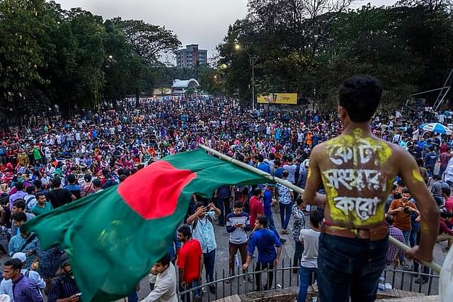 A protestor waves a Bangladeshi flag during an anti-reservation rally. (pic via Twitter)