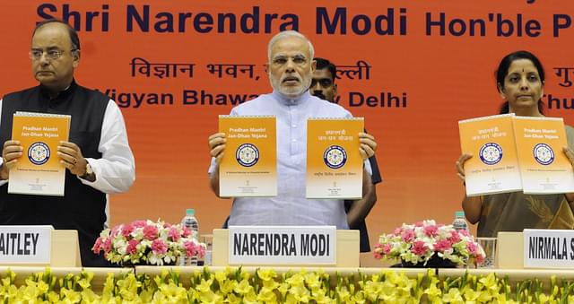 Prime Minister Narendra Modi launching the Pradhan Mantri Jan Dhan Yojana with Finance Minister Arun Jaitley and former Commerce Minister Nirmala Sitharaman in August 2014 (Mohd Zakir/Hindustan Times via Getty Images)