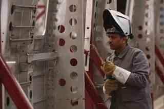 A worker  welds the fuselage of a subway car destined for New Delhi (Sean Gallup/Getty Images)