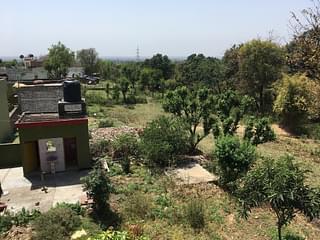 View from the terrace of Veena Devi’s house. The green house with a washbasin visible in the photo is that of Sanji Ram. The cot on the roof is where the juvenile accused was sleeping.