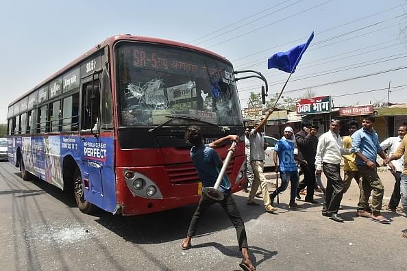 Members of a dalit organisation damaging a BRTS bus during Bharat Bandh called by Dalit organisations on April 2 in Bhopal. (Photo by Mujeeb Faruqui/Hindustan Times via Getty Images)