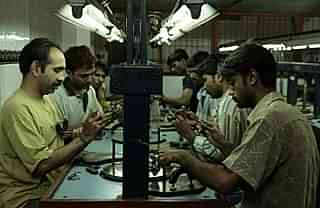 Workers polish diamonds at a factory in Dahisar near Mumbai. (Satish Bate/Hindustan Times via Getty Images)