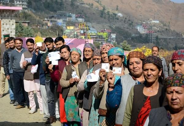 Women showing their voting cards before casting their votes for Himachal assembly elections at Theog in Shimla. (Deepak Sansta/Hindustan Times via Getty Images)