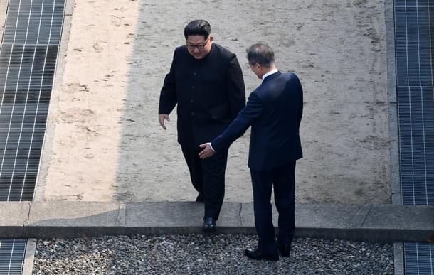 North Korean leader Kim Jong Un, left, greets his counterpart as he crosses the military demarcation line, before meeting with South Korean President Moon Jae-in for the Inter-Korean Summit in Panmunjom, South Korea. (Korea Summit Press Pool/Getty Images) 