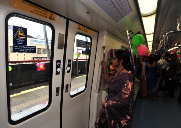 A commuter stands by the door on the Namma Metro in Bengaluru. (Jagdeesh MV/Hindustan Times via Getty Images) 