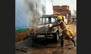 Fire station personnel putting out a blaze engulfing a vehicle in Bomminaickanpatti.