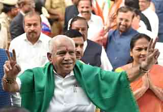 B S Yeddyurappa shows victory sign after taking oath as the 23rd Chief Minister of Karnataka in Bengaluru. (Arijit Sen/Hindustan Times via GettyImages)