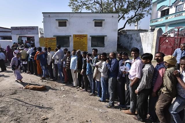Voters line up to cast their votes at a polling station in Ayodhya. (Arun Sharma/Hindustan Times via Getty Images)