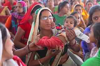 A girl in her mother’s lap in Rajasthan. (Himanshu Vyas/Hindustan Times via Getty Images)