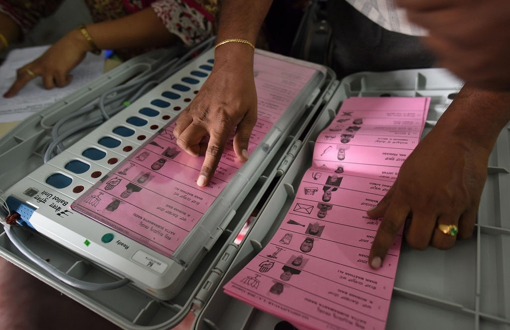 A polling staff tallies the candidates names on the Electronic Voting Machines (EVM) (Arijit Sen/Hindustan Times via Getty Images)
