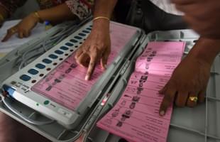 A polling staff tallies the candidates names on the Electronic Voting Machines (EVM) (Arijit Sen/Hindustan Times via Getty Images)