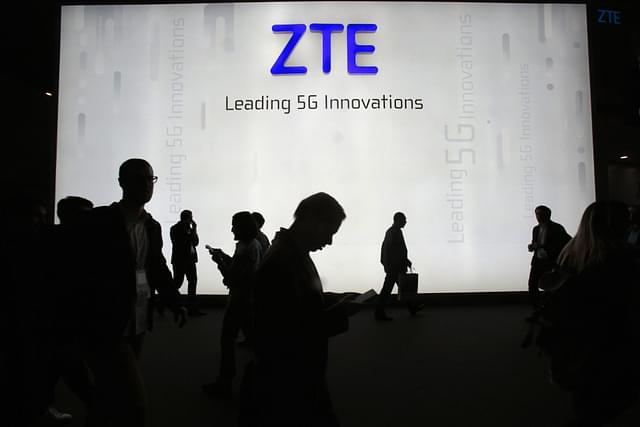 People walk in front a ZTE stand at the World Mobile Congress 2018 in Barcelona (Miquel Benitez/Getty Images)