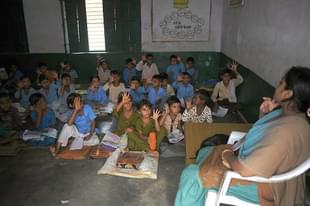 Indian school children read in a classroom at a government school in Bagpath district in Uttar Pradesh. (SAJJAD HUSSAIN/AFP/Getty Images)