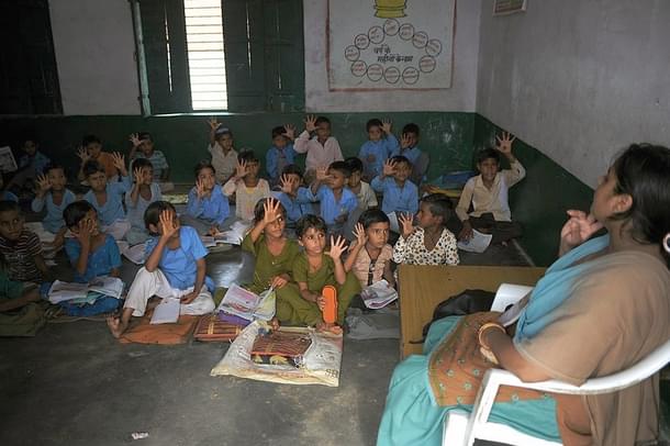 Indian school children read in a classroom at a government school in Bagpath district in Uttar Pradesh. (SAJJAD HUSSAIN/AFP/Getty Images)