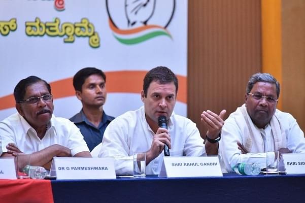 All India Congress Committee president Rahul Gandhi flanked by Karnataka Pradesh Congress Committee president G Parmeshwara (L) and Karnataka Chief Minister Siddaramaiah (R) during a press conference on the last day of campaigning ahead of state assembly election at a city hotel on 10 May 2018 in Bengaluru. (Arijit Sen/Hindustan Times via Getty Images)